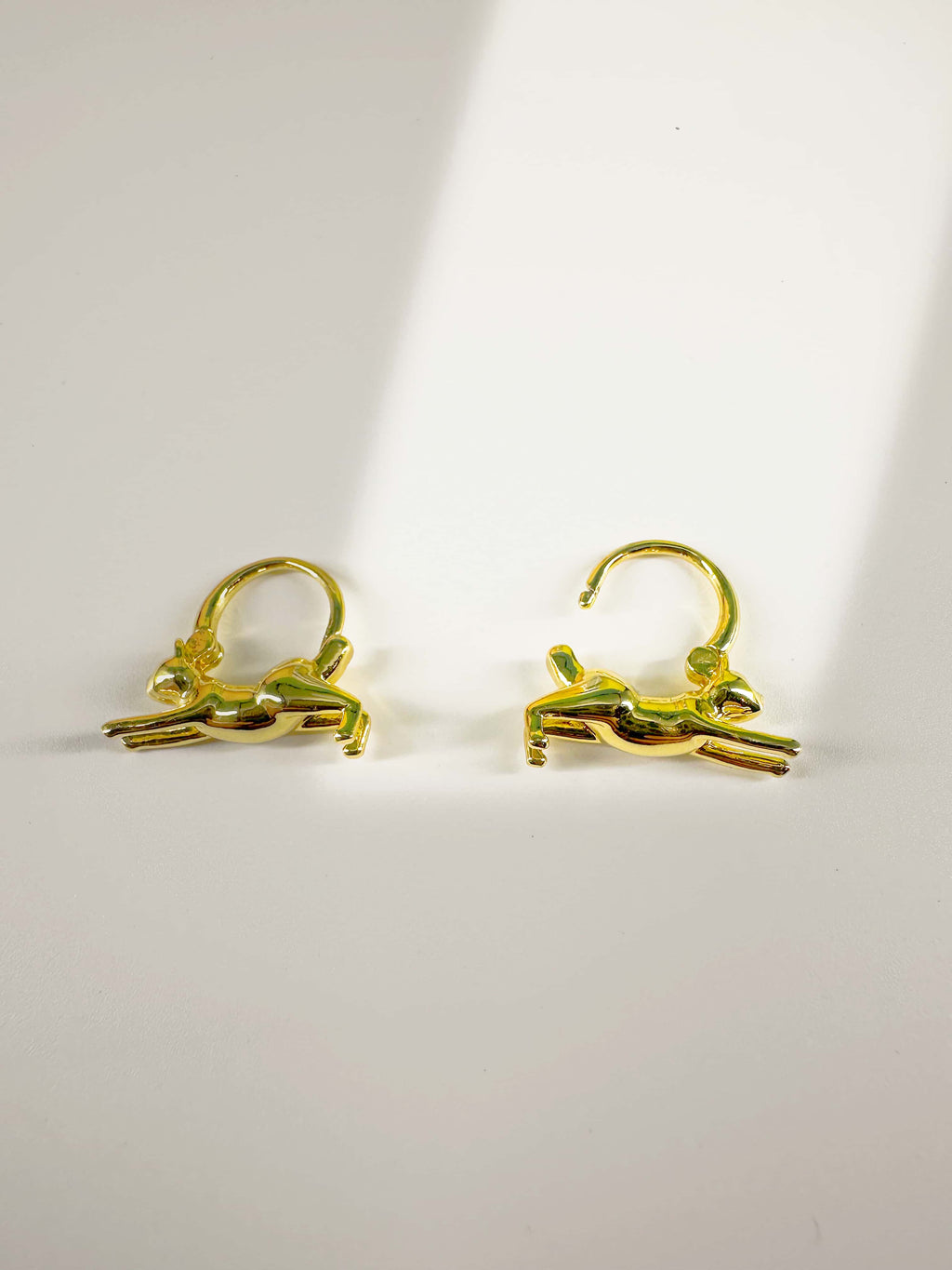 Pair of 18K gold plated cat earrings for women showcasing the leaping cat structure and clasp mechanism