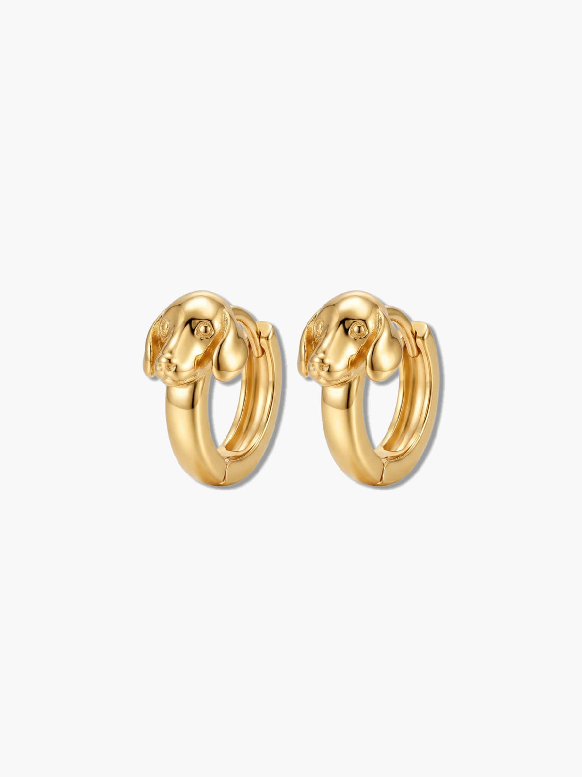 A pair of 18K gold plated dog earrings featuring a sculpted puppy huggie hoop design on a plain background