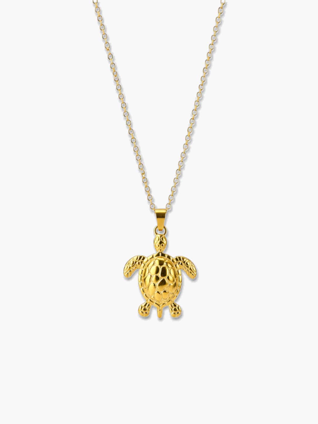A high-quality studio shot of a polished 18K gold sea turtle necklace pendant against a clean, light gray background