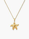 A detailed product shot of an 18K gold starfish necklace with an intricately textured star pendant on a delicate gold chain over a white background