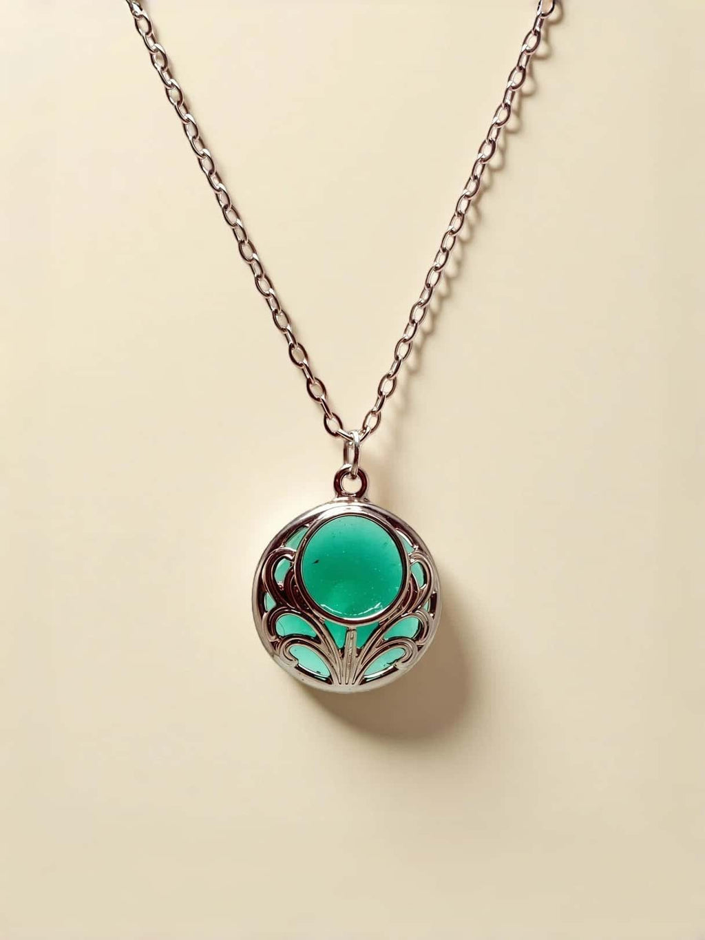 Necklace with a green pendant on a beige background