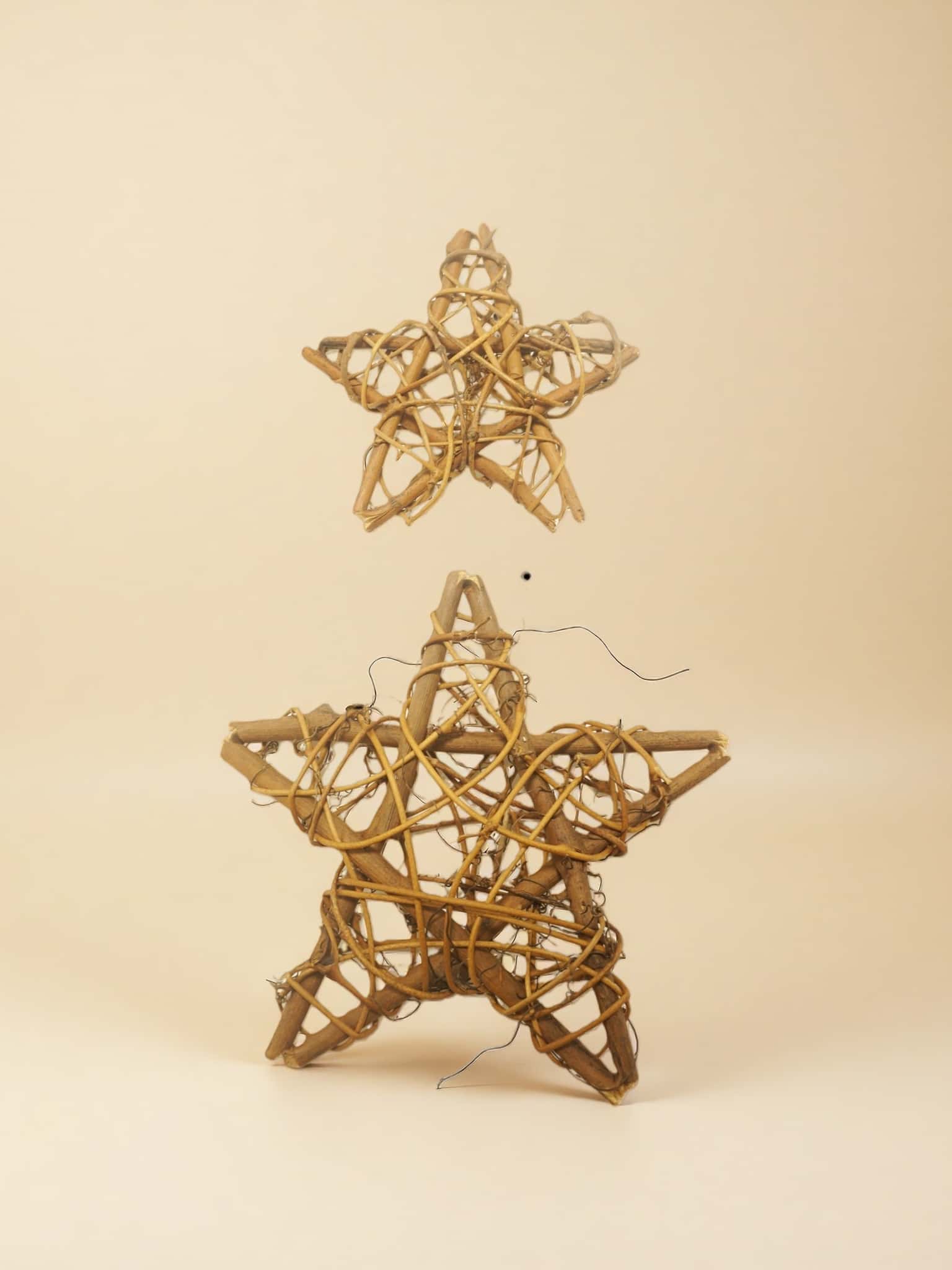 Decorative start ornaments object made of woven material on a beige background
