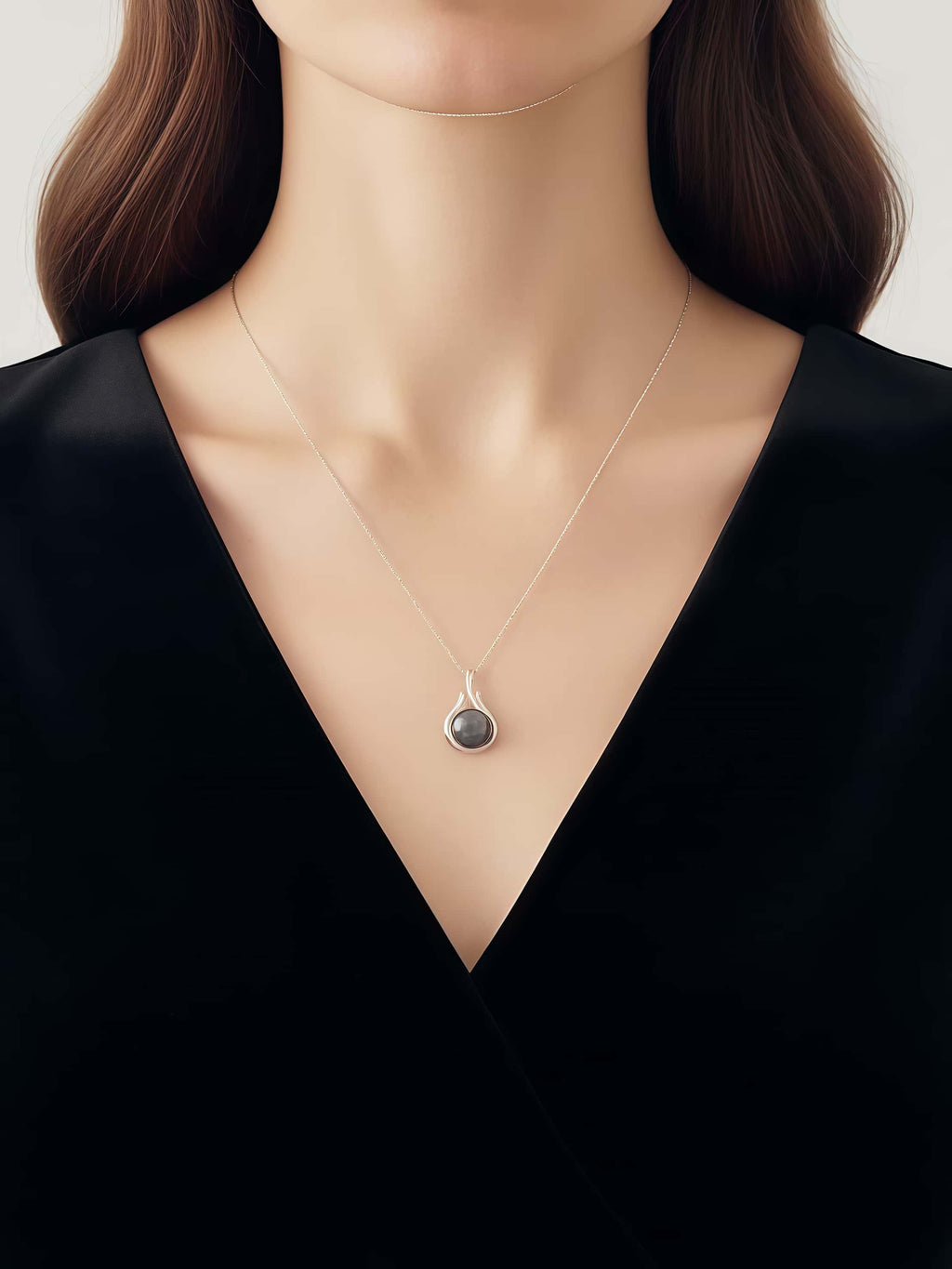 Necklace with a pendant on a model wearing a black top