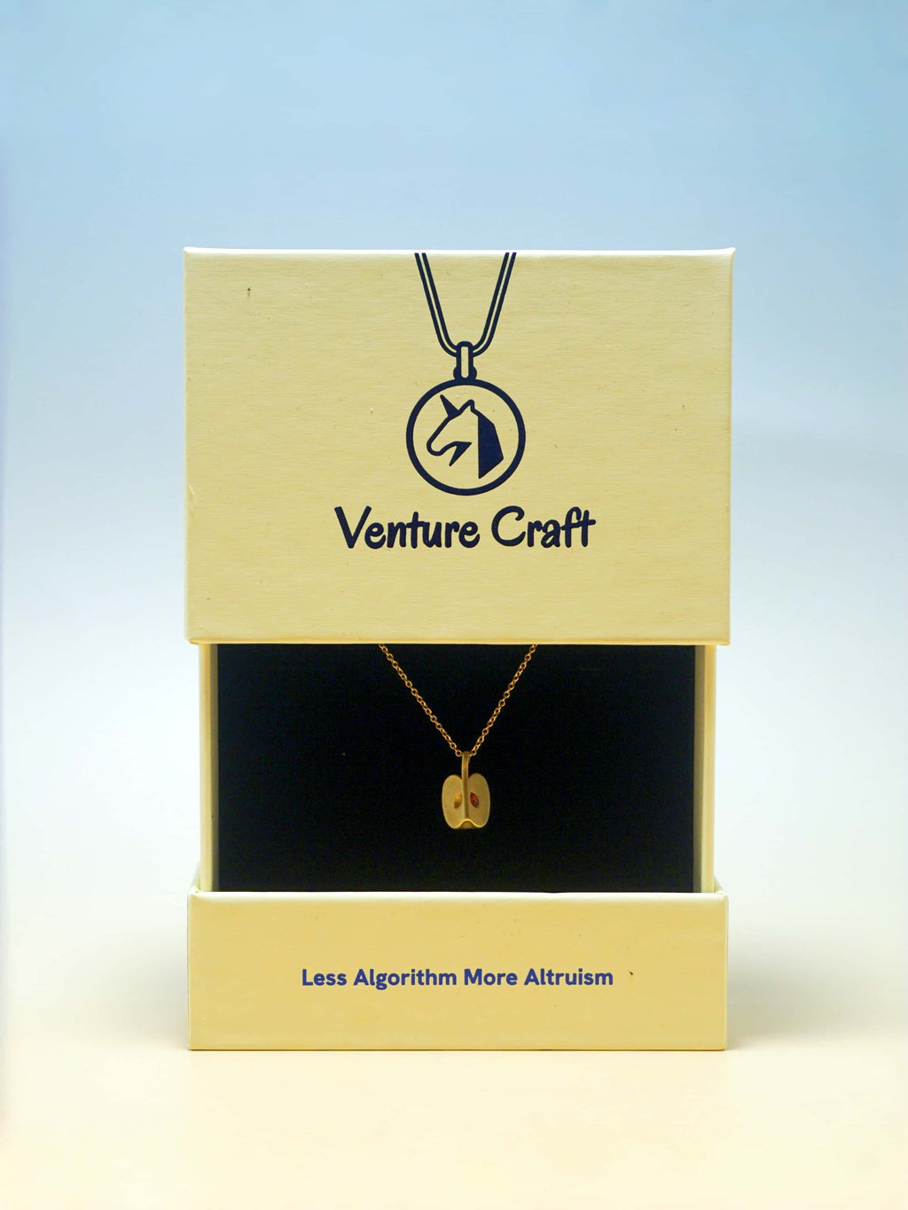 Venture Craft necklace in packaging with a blue gradient background