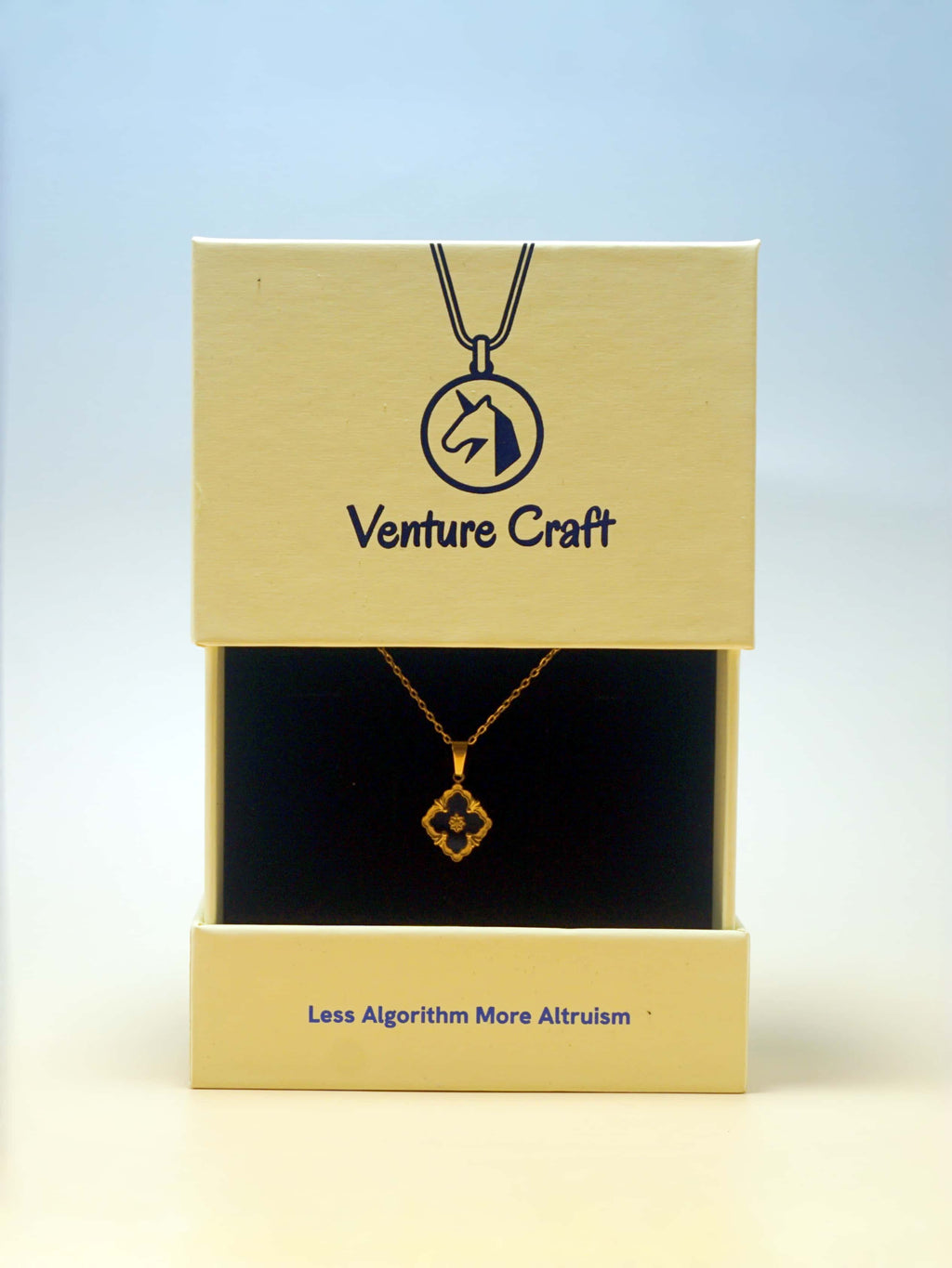 Gold necklace in a 'Venture Craft' box with a blue gradient background