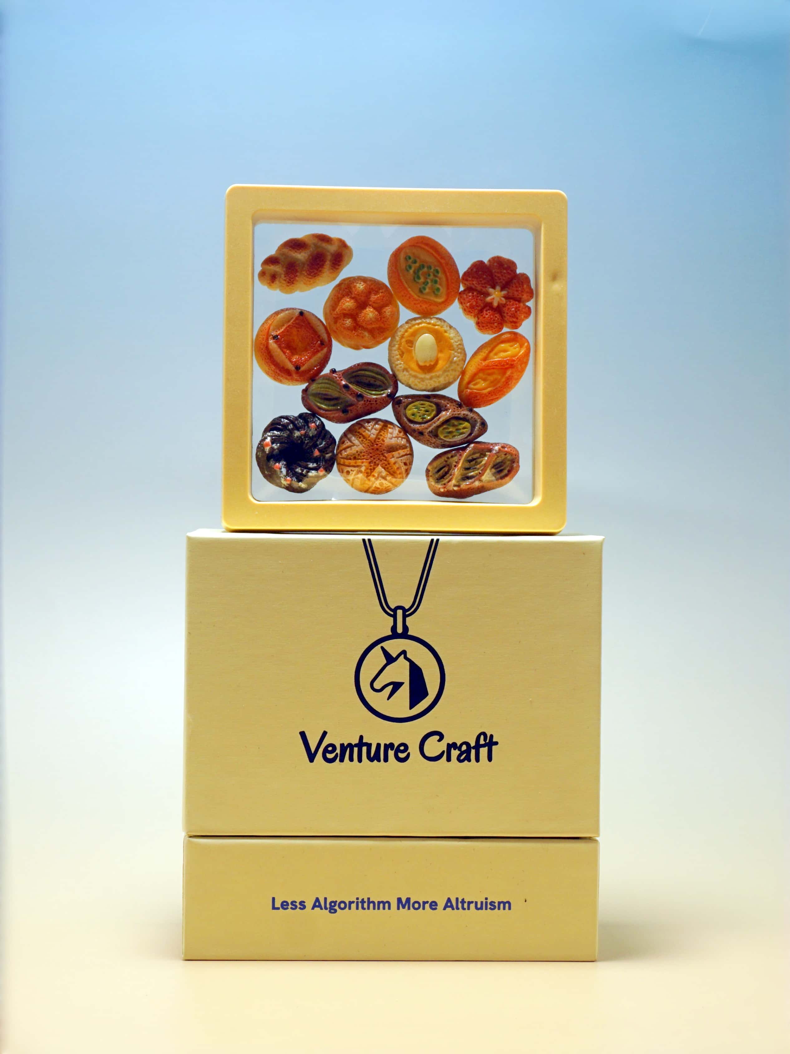 Box of Venture Craft with colorful stones on a light blue background