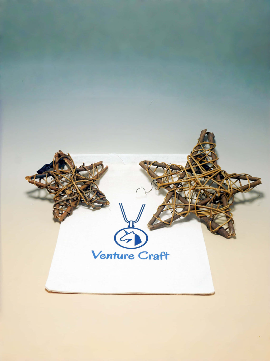 Two woven star ornaments on a white card with 'Venture Craft' logo against a gradient background.
