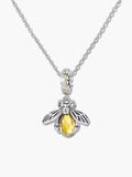 High-resolution macro shot of a bee pendant necklace, showcasing the intricate S925 silver wing details, sparkling zircon crown, and faceted yellow crystal body