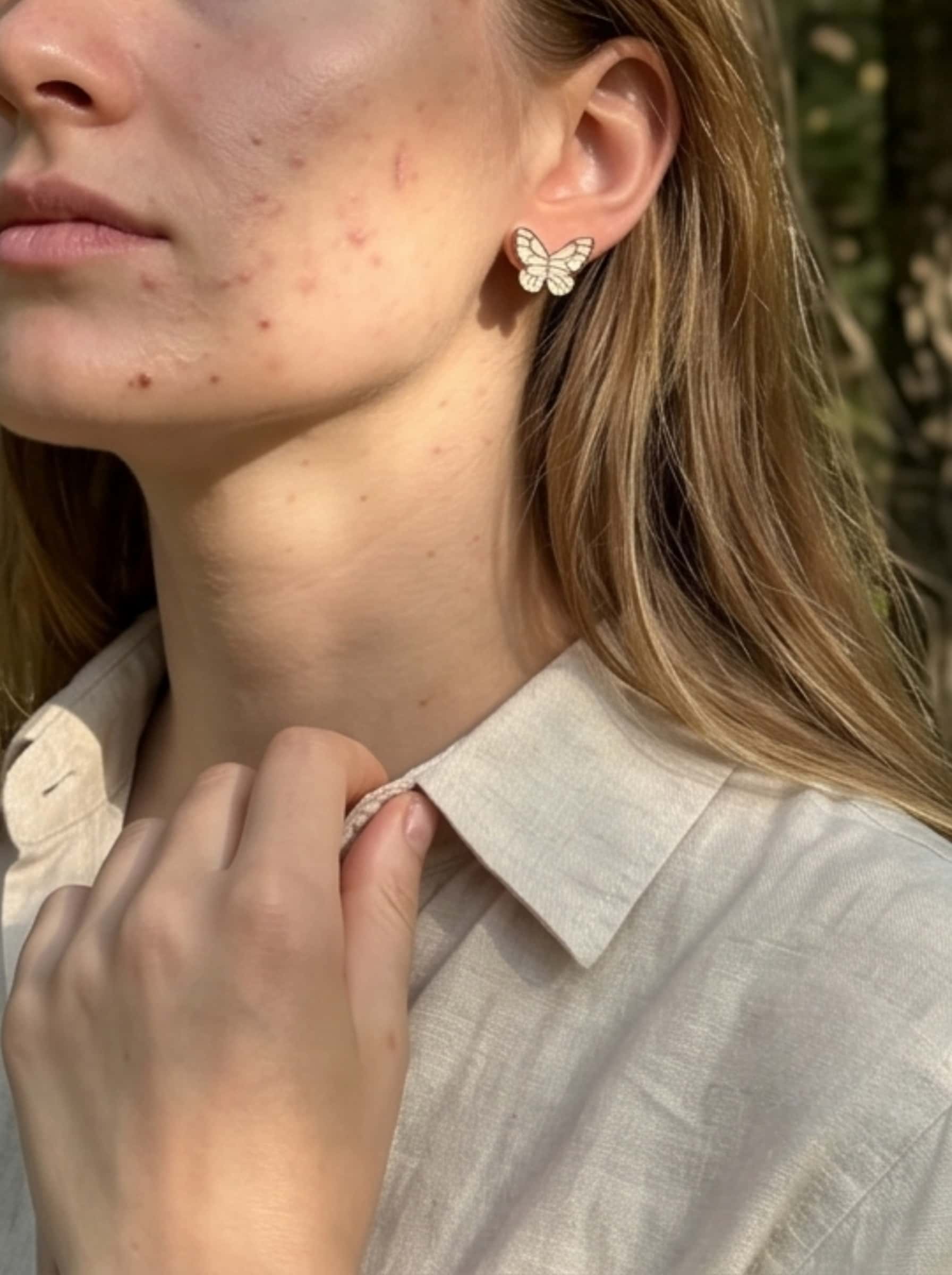 Organic modern lifestyle photography of butterfly stud earrings, capturing beautiful botanical leaf shadows on a model for a vintage nature vibe