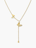 Studio vertical shot of the butterfly pendant necklace, showcasing the smaller gold butterfly on the side chain and the larger crystal-embellished butterfly leading to a dangling bead