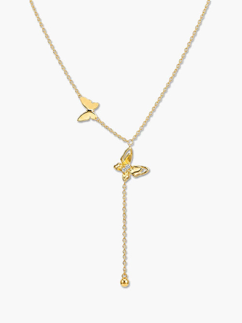Studio vertical shot of the butterfly pendant necklace, showcasing the smaller gold butterfly on the side chain and the larger crystal-embellished butterfly leading to a dangling bead