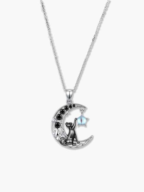 Clean studio product shot of a silver cat necklace adorned with black gemstones and a dangling moonstone charm on a white background