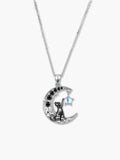 Clean studio product shot of a silver cat necklace adorned with black gemstones and a dangling moonstone charm on a white background