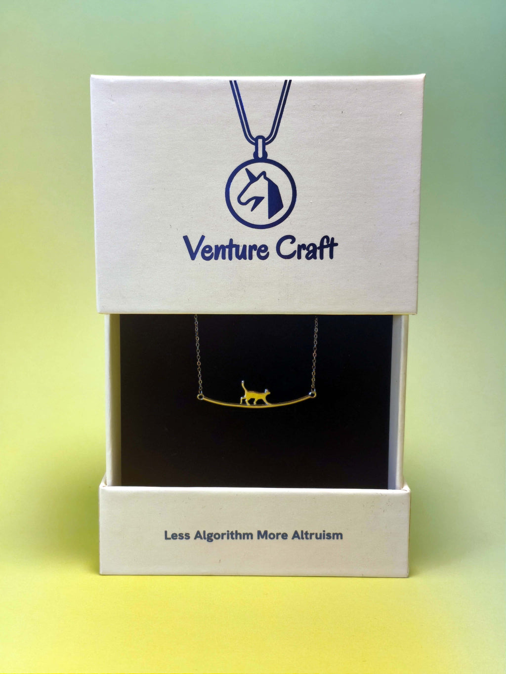 Venture Craft cat necklace packaging with a gift box in a gradient background