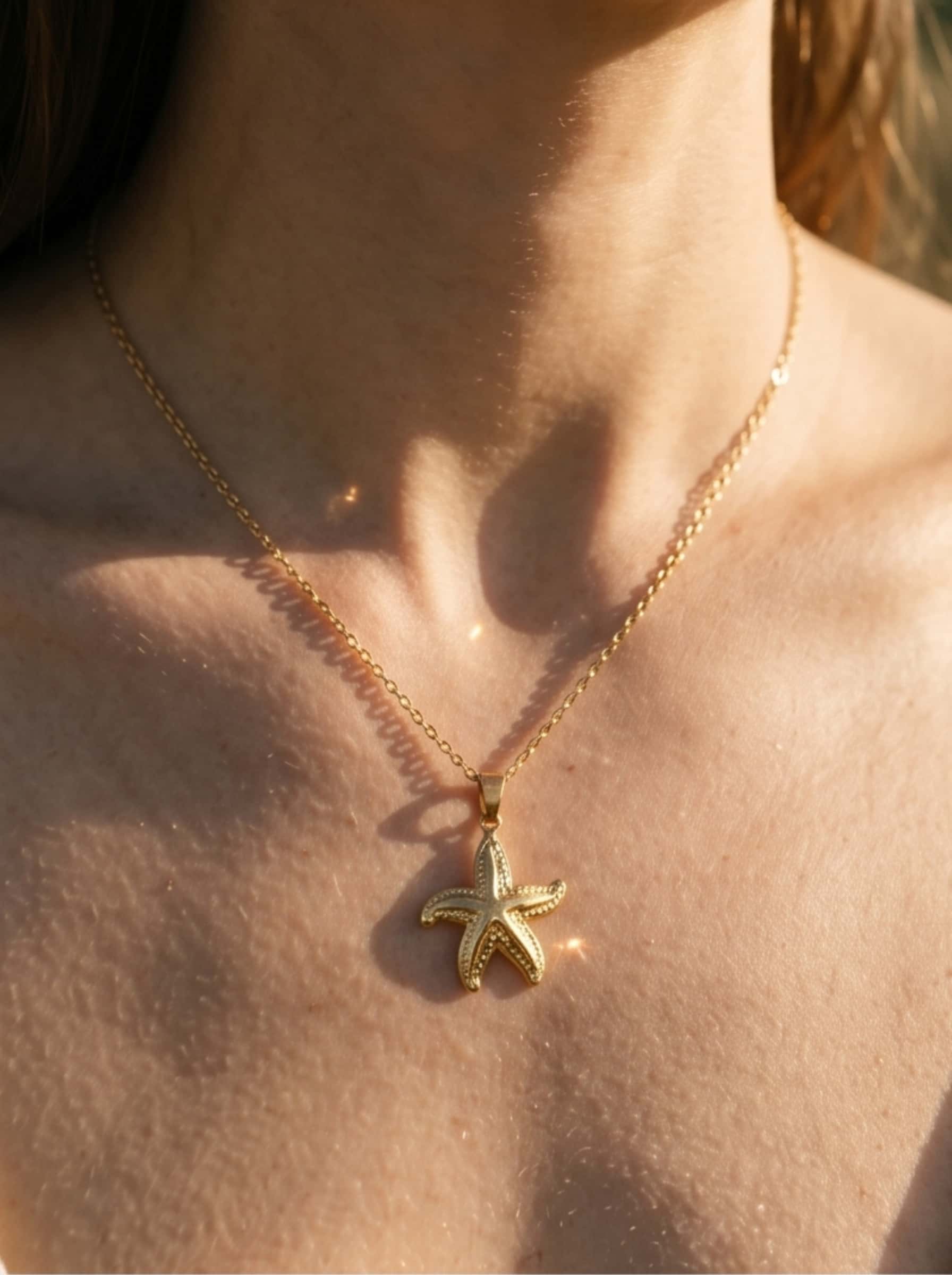 Macro view highlighting the fine textures, premium craftsmanship, and polished finish of the pendant on the gold starfish necklace