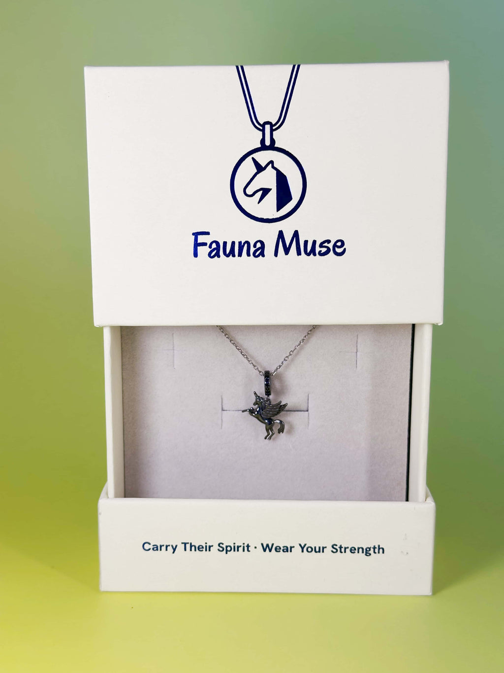 Fauna Muse dark silver winged unicorn pendant necklace displayed inside a white branded gift box