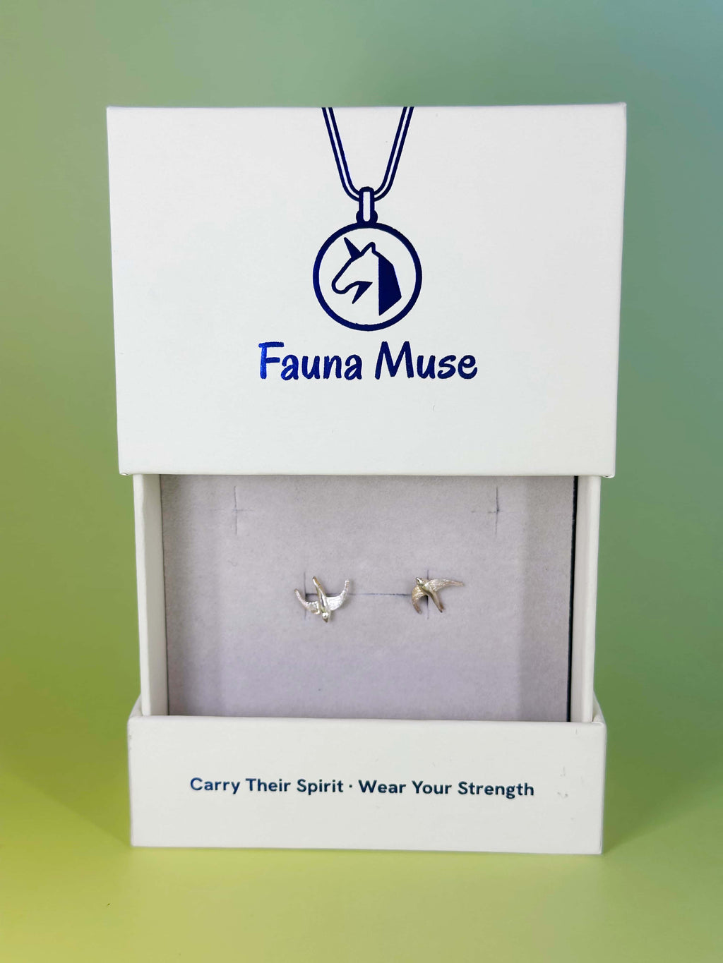 Fauna Muse silver flying bird stud earrings displayed in a white branded jewelry gift box