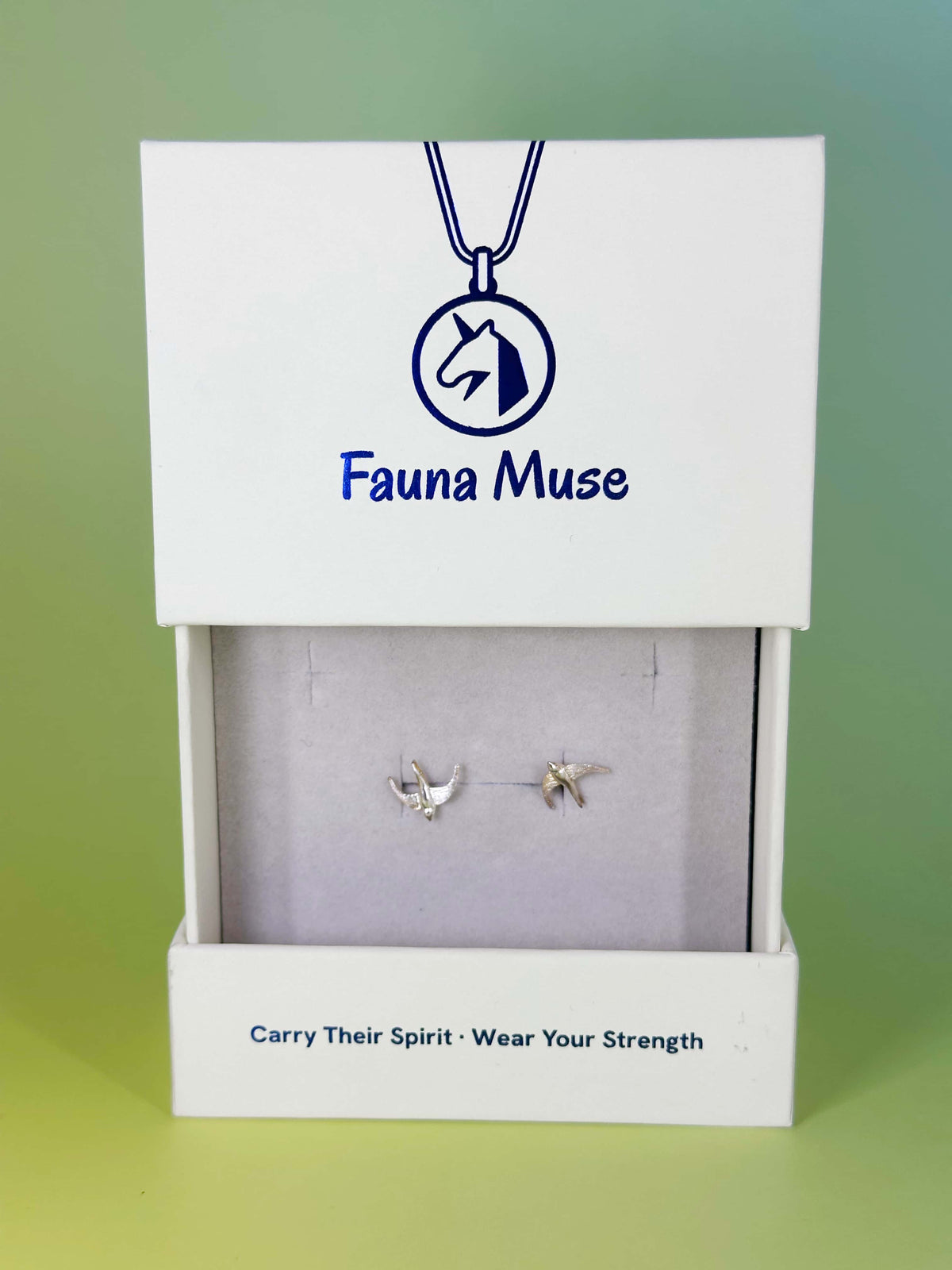 Fauna Muse silver flying bird stud earrings displayed in a white branded jewelry gift box