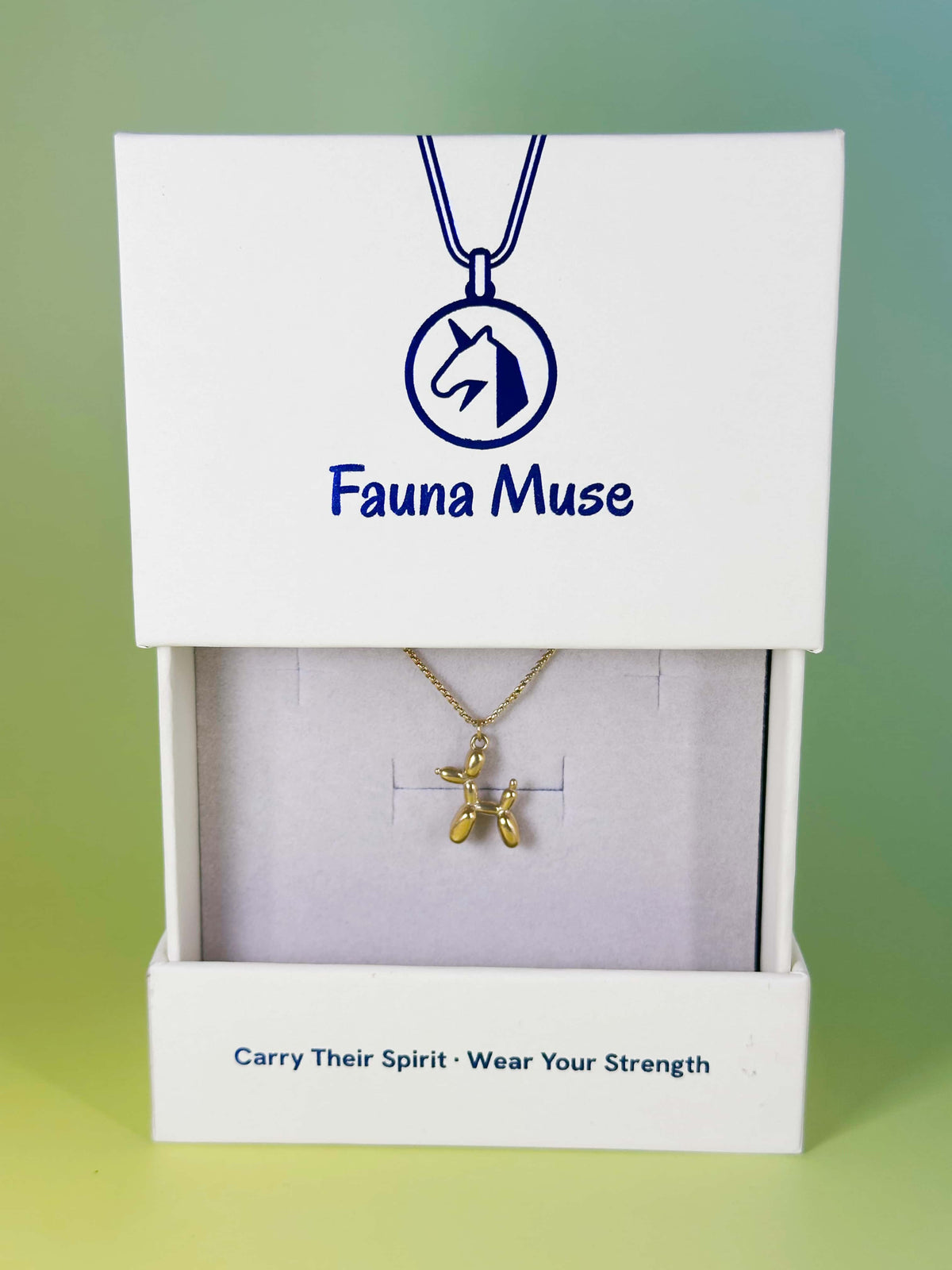 Fauna Muse gold balloon dog pendant necklace displayed inside a white branded gift box