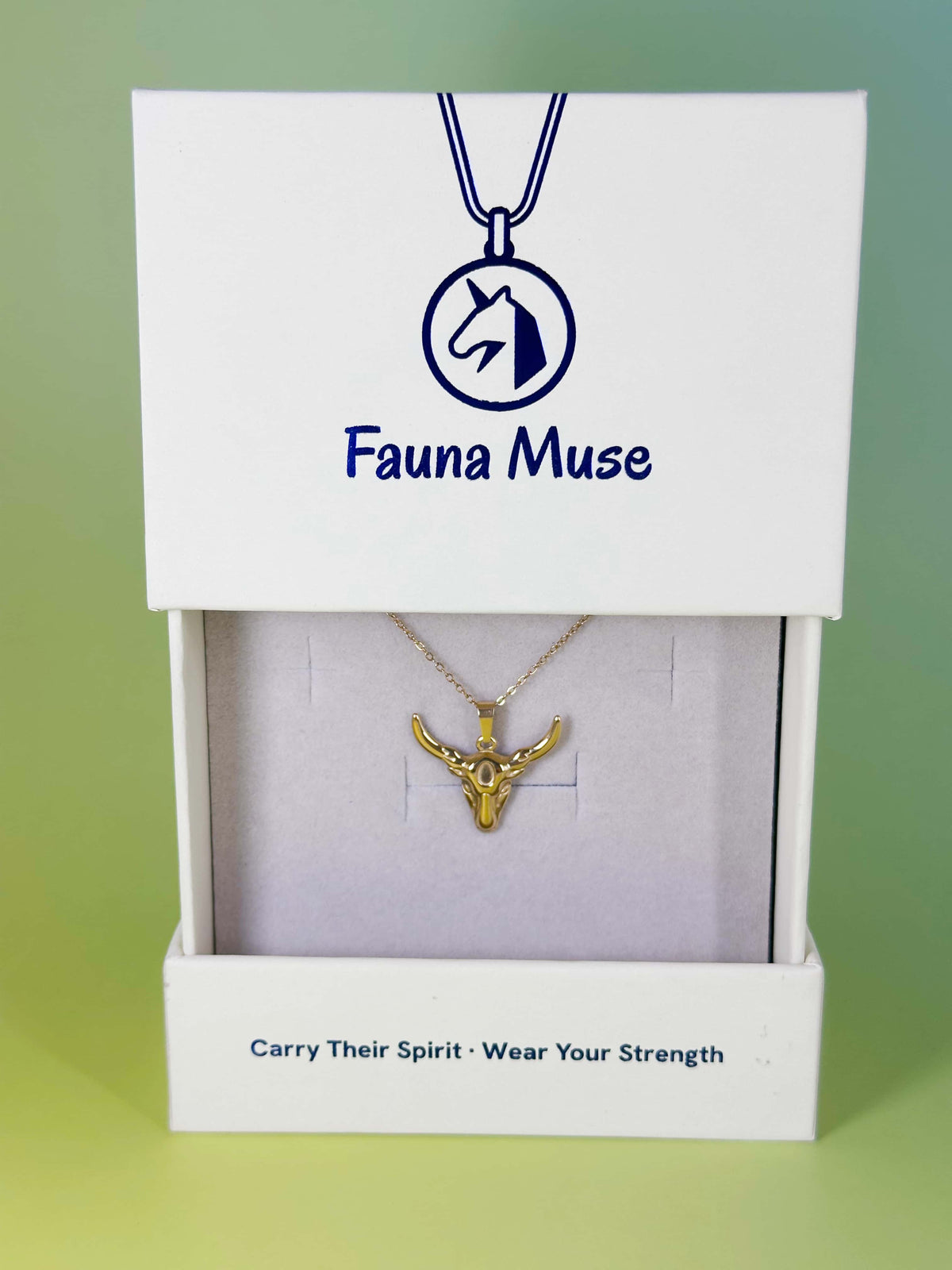 Fauna Muse gold bull head pendant necklace displayed inside a white branded gift box