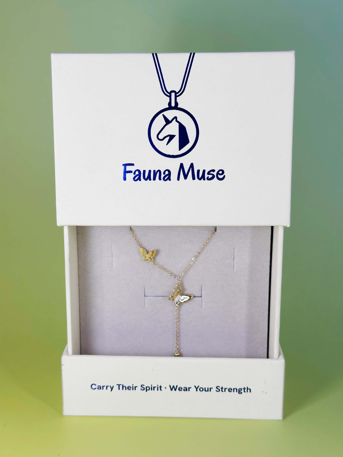 Fauna Muse gold double butterfly lariat necklace displayed inside a white branded gift box