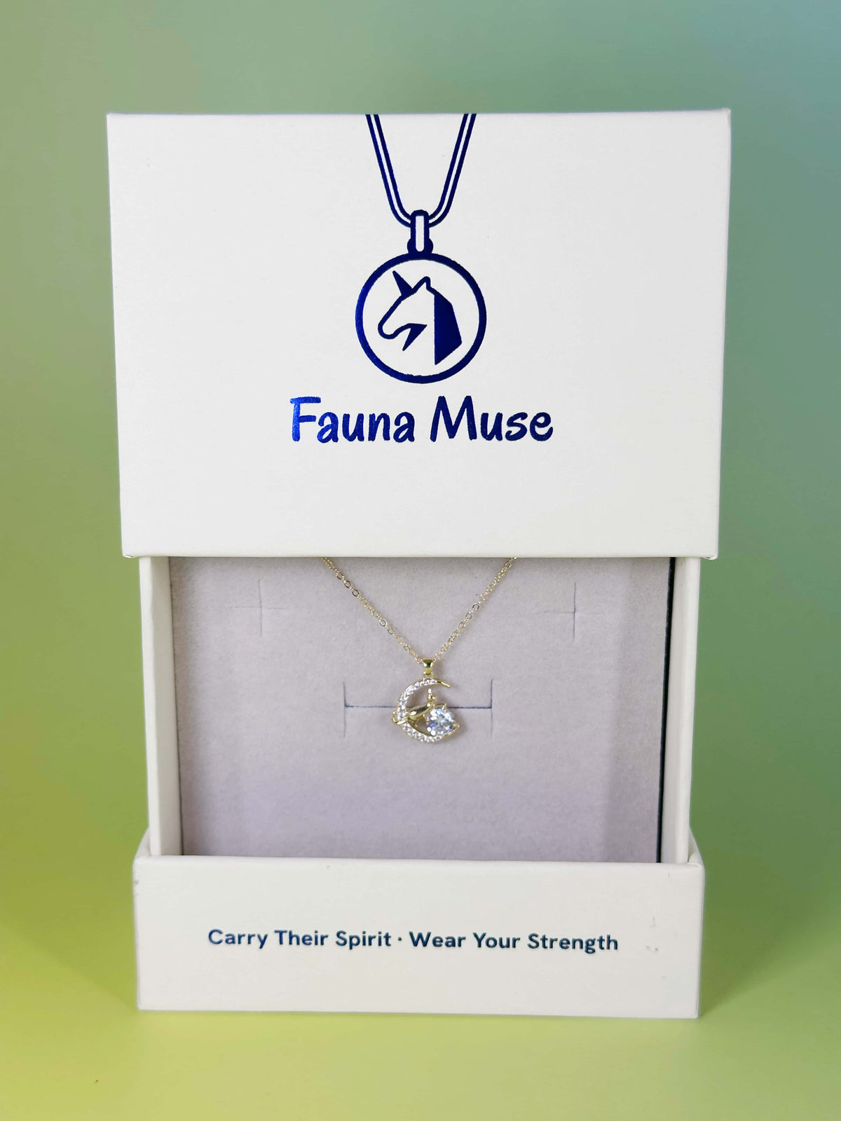 Fauna Muse gold cat on crystal crescent moon pendant necklace displayed inside a white branded gift box