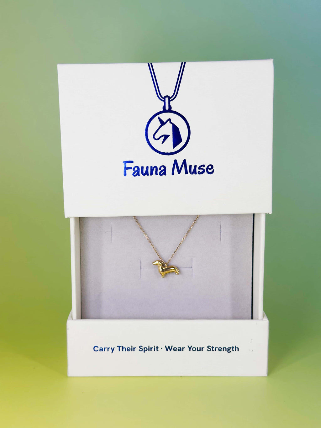 Fauna Muse gold dachshund dog pendant necklace displayed inside a white branded gift box