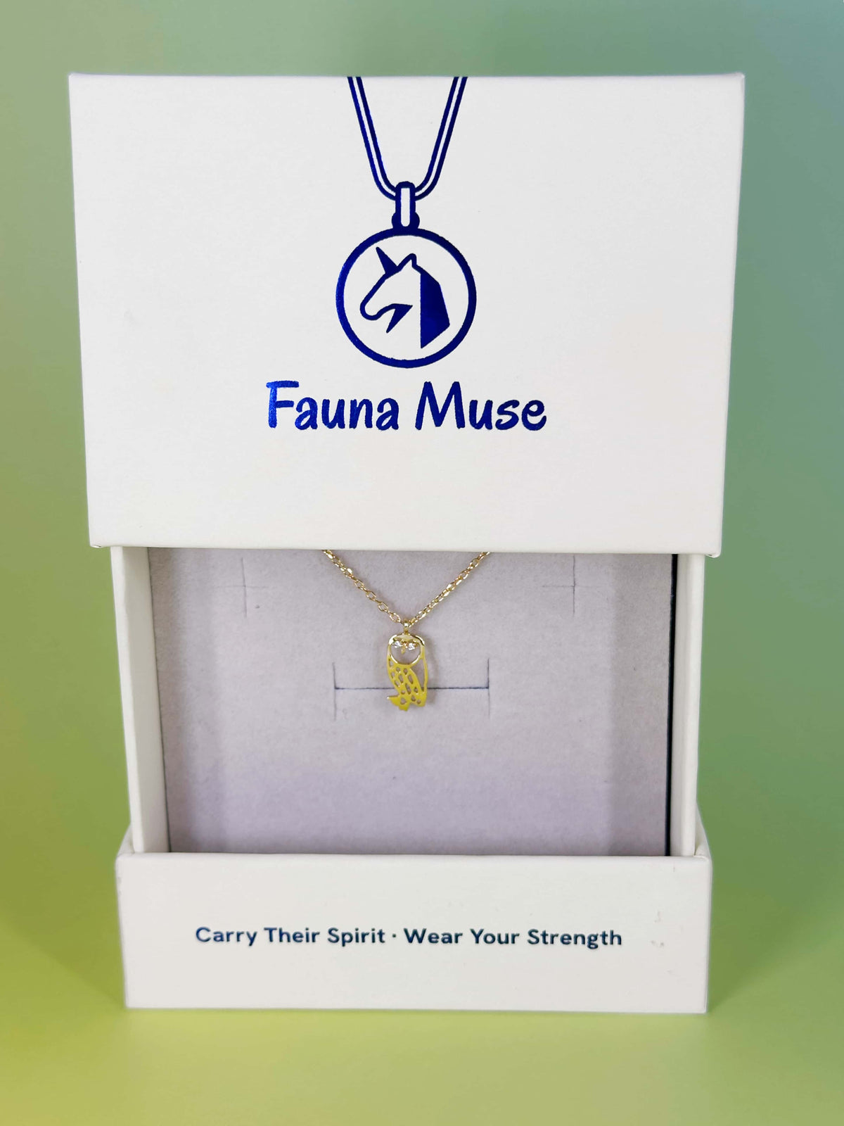 Fauna Muse gold dainty owl pendant necklace with sparkling crystal eyes displayed inside a white branded gift box