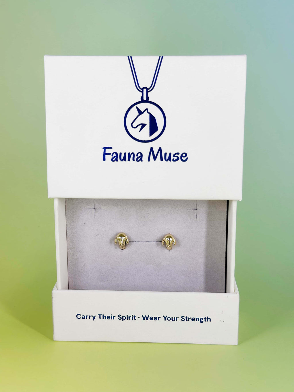 Fauna Muse gold dog head stud earrings displayed in a white branded jewelry gift box