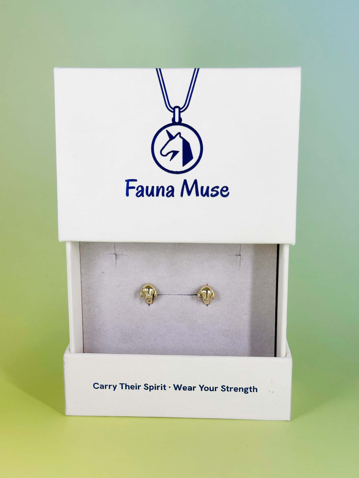 Fauna Muse gold dog head stud earrings displayed in a white branded jewelry gift box