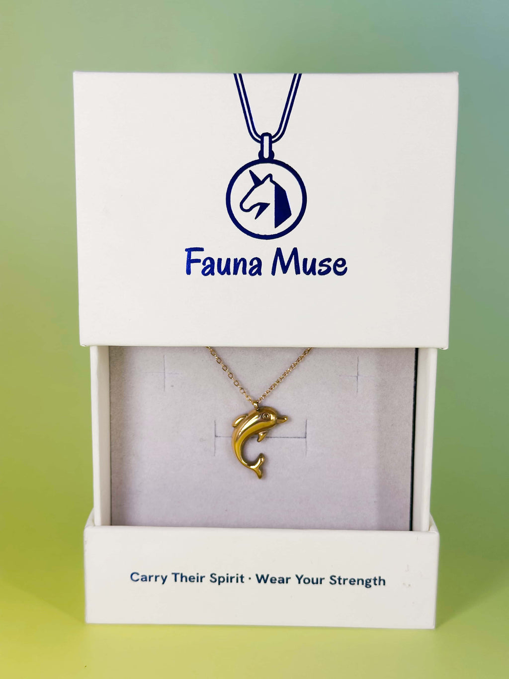 Fauna Muse gold dolphin pendant necklace displayed inside a white branded gift box