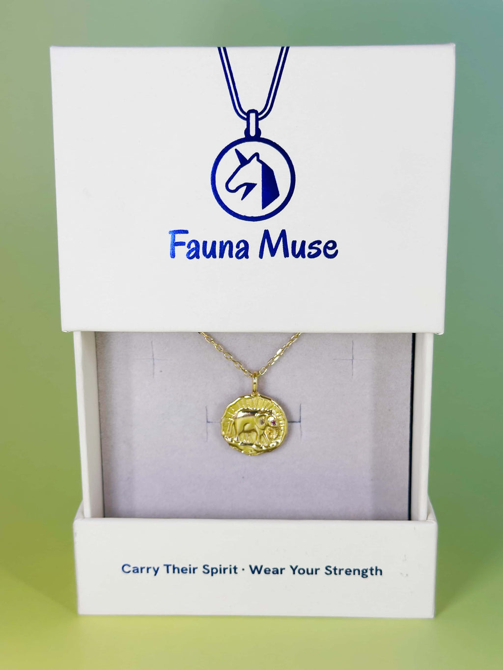Fauna Muse gold elephant coin pendant necklace displayed inside a white branded gift box