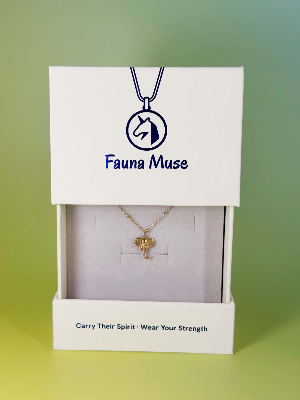 Fauna Muse gold elephant pendant necklace displayed inside a white branded gift box