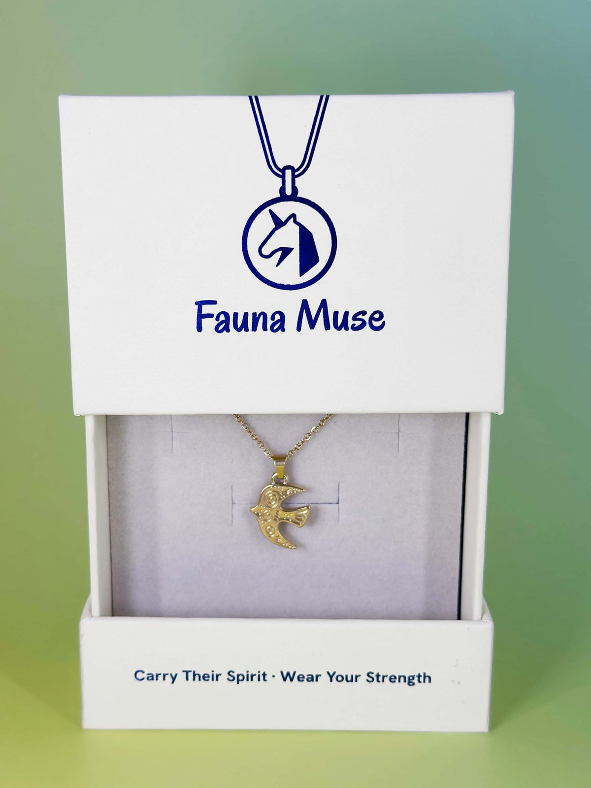 Fauna Muse gold engraved swallow bird pendant necklace displayed inside a white branded gift box