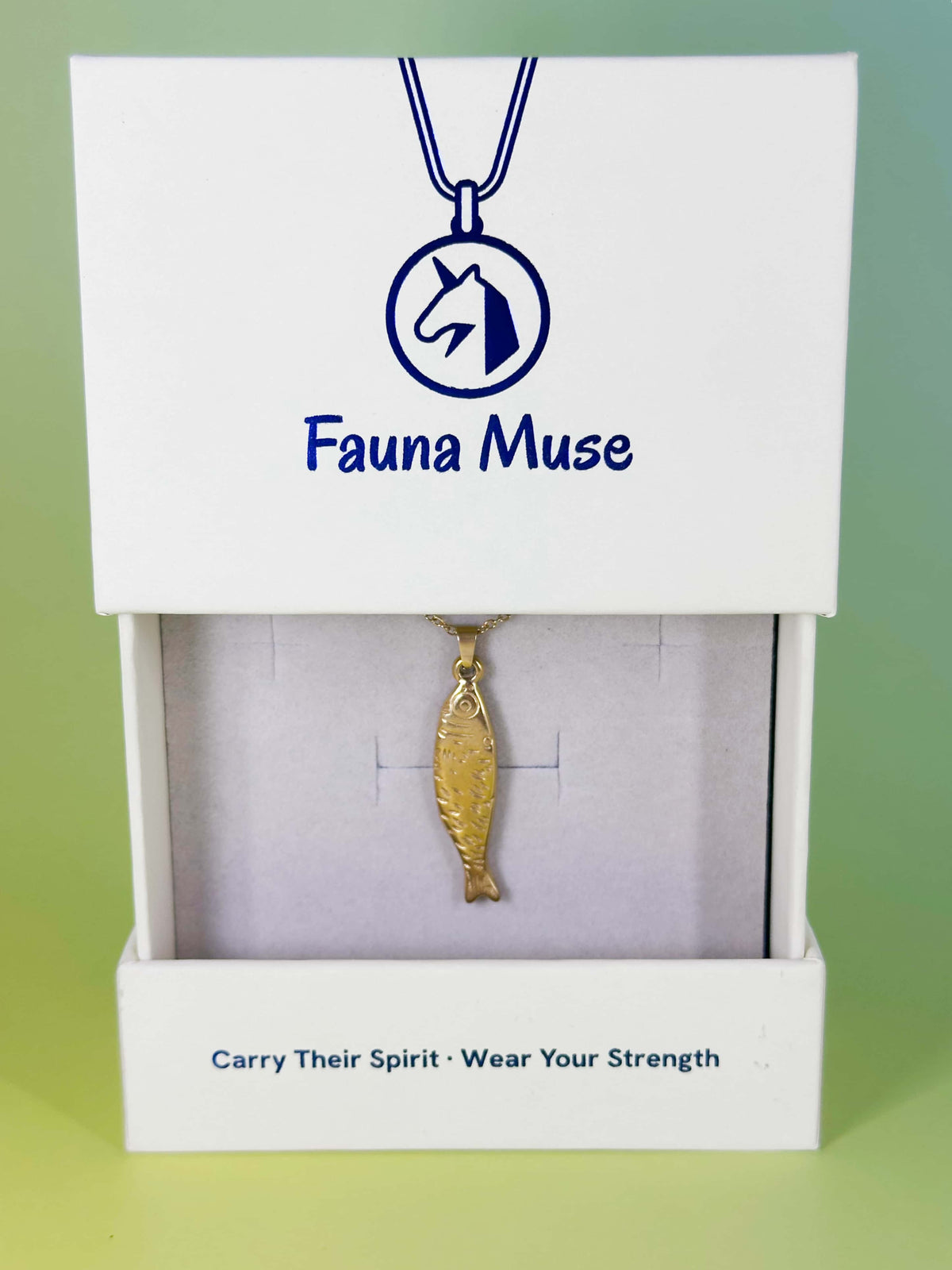 Fauna Muse gold fish pendant necklace displayed inside a white branded gift box