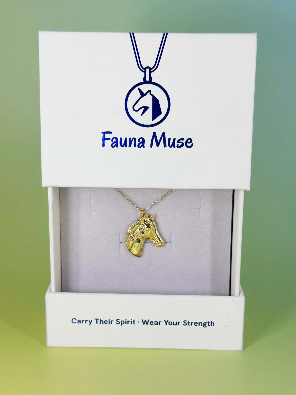 Fauna Muse gold horse head pendant necklace displayed inside a white branded gift box