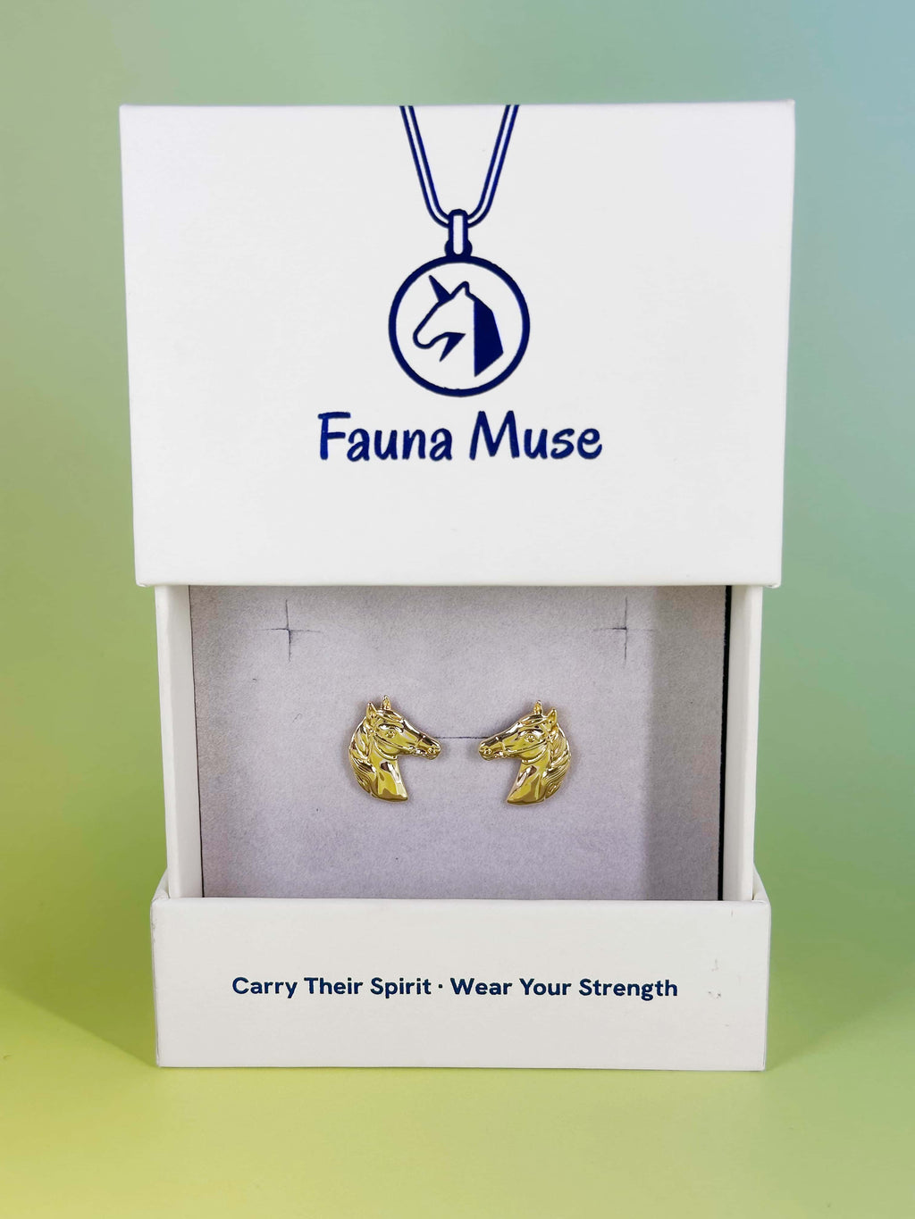 Fauna Muse gold horse head stud earrings displayed in a white branded jewelry gift box