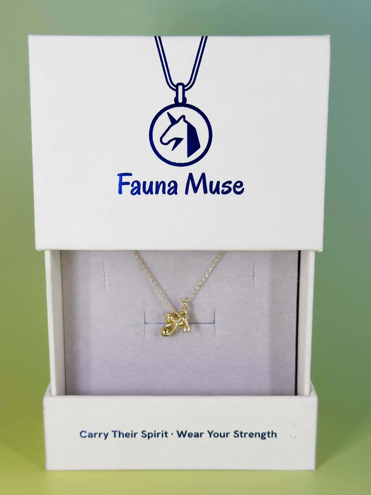 Fauna Muse gold playful cat playing with ball pendant necklace displayed inside a white branded gift box