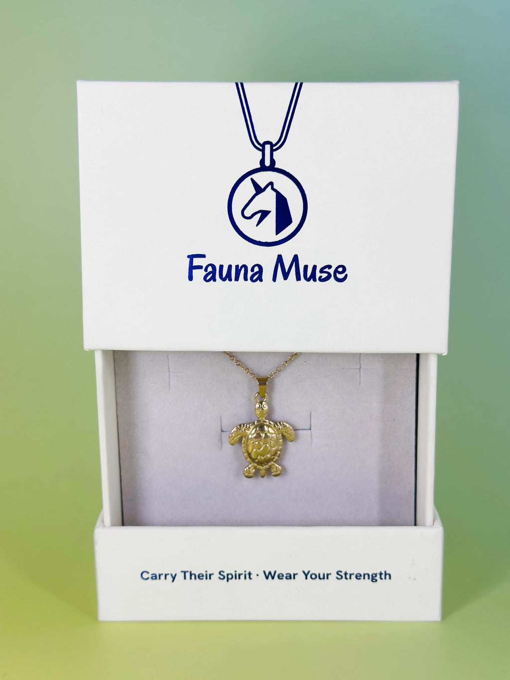 Fauna Muse gold sea turtle pendant necklace displayed inside a white branded gift box