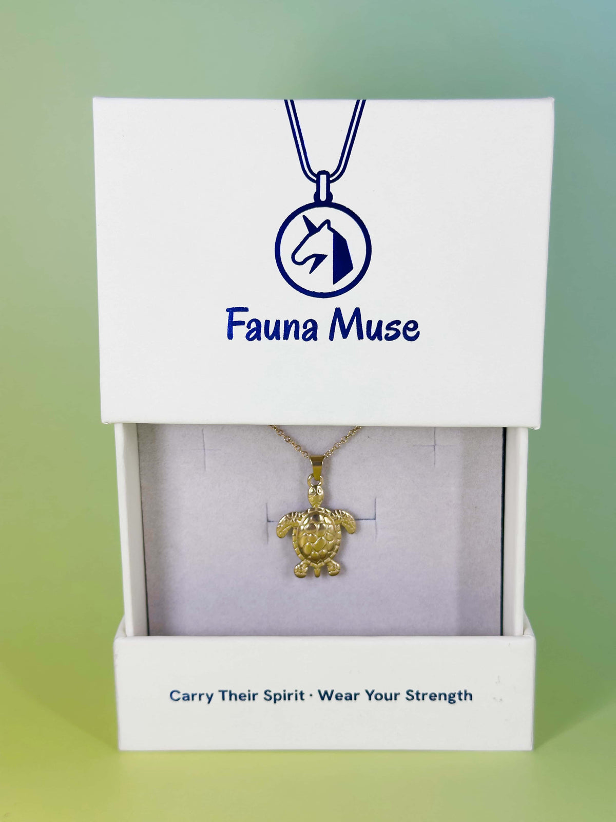 Fauna Muse gold sea turtle pendant necklace displayed inside a white branded gift box