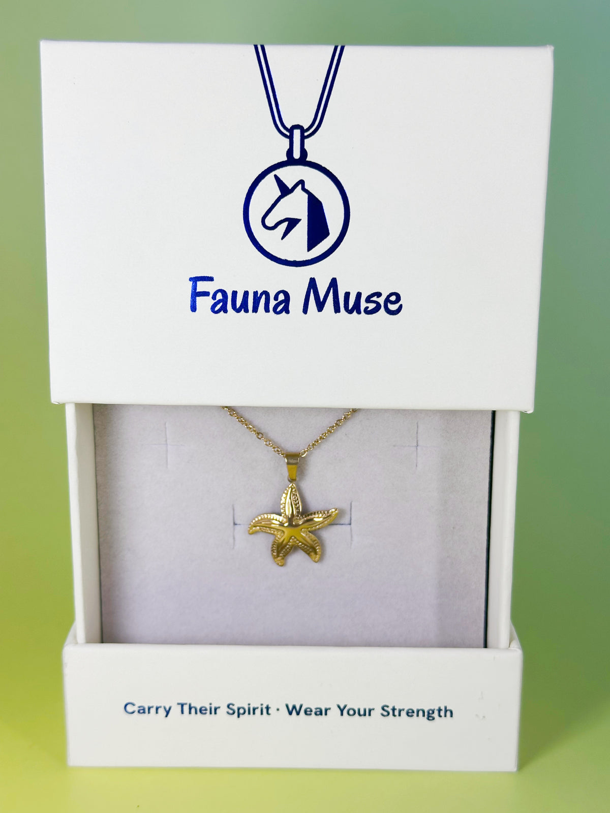 Fauna Muse gold starfish pendant necklace displayed inside a white branded gift box