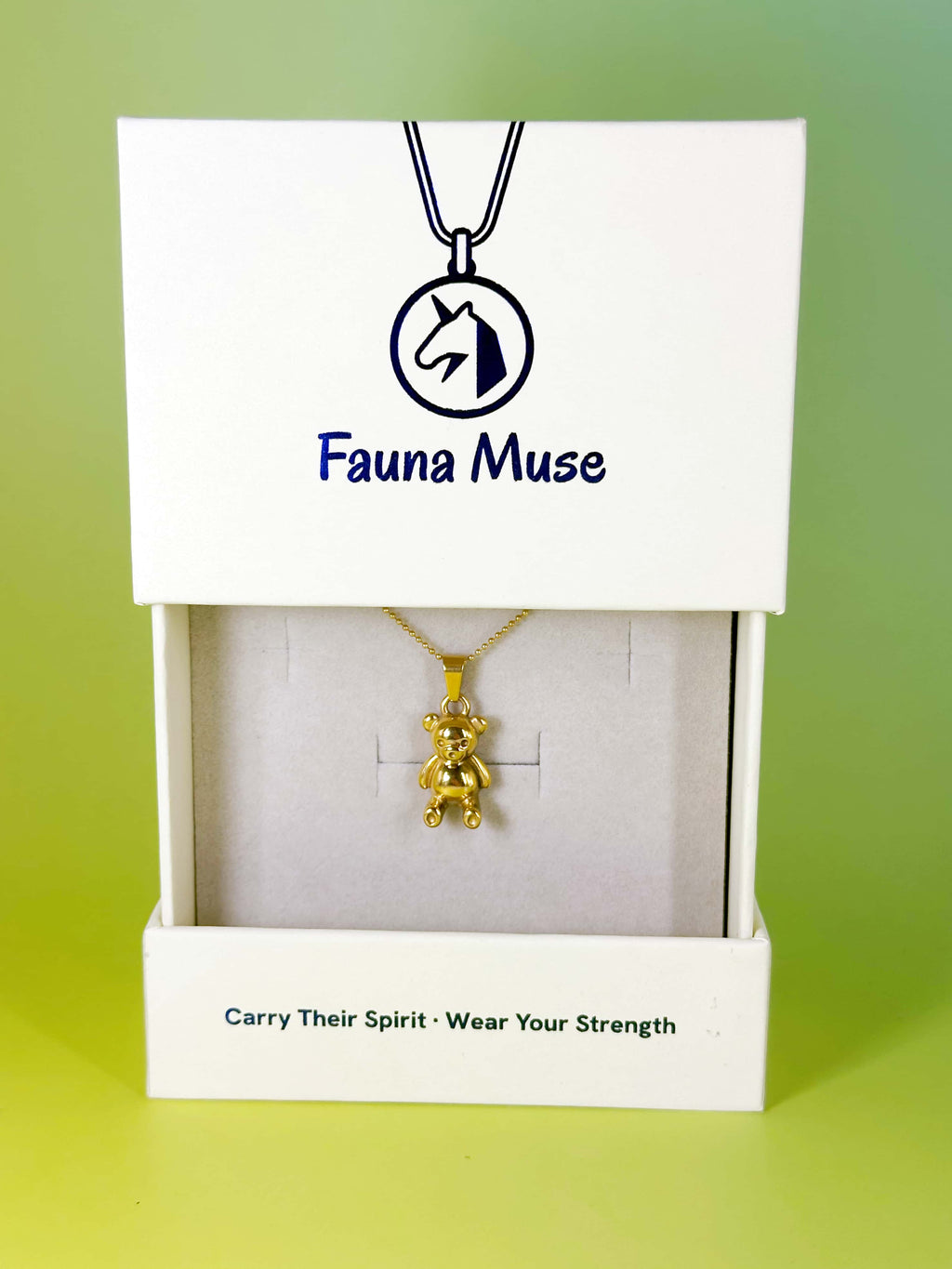 Fauna Muse gold teddy bear pendant necklace displayed inside a white branded gift box