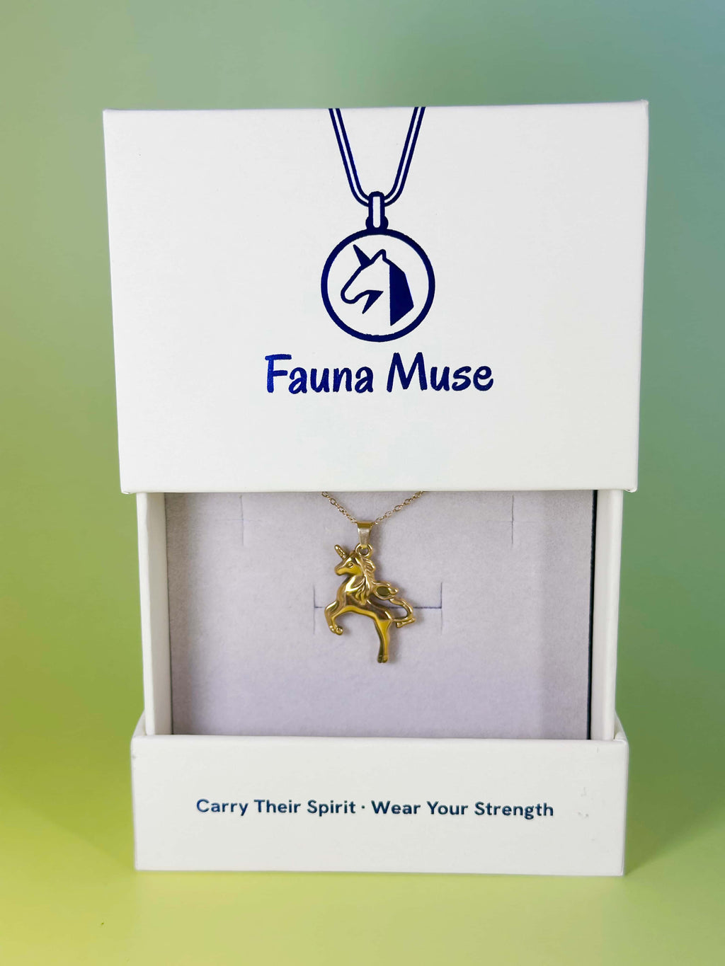 Fauna Muse gold unicorn pendant necklace displayed inside a white branded gift box