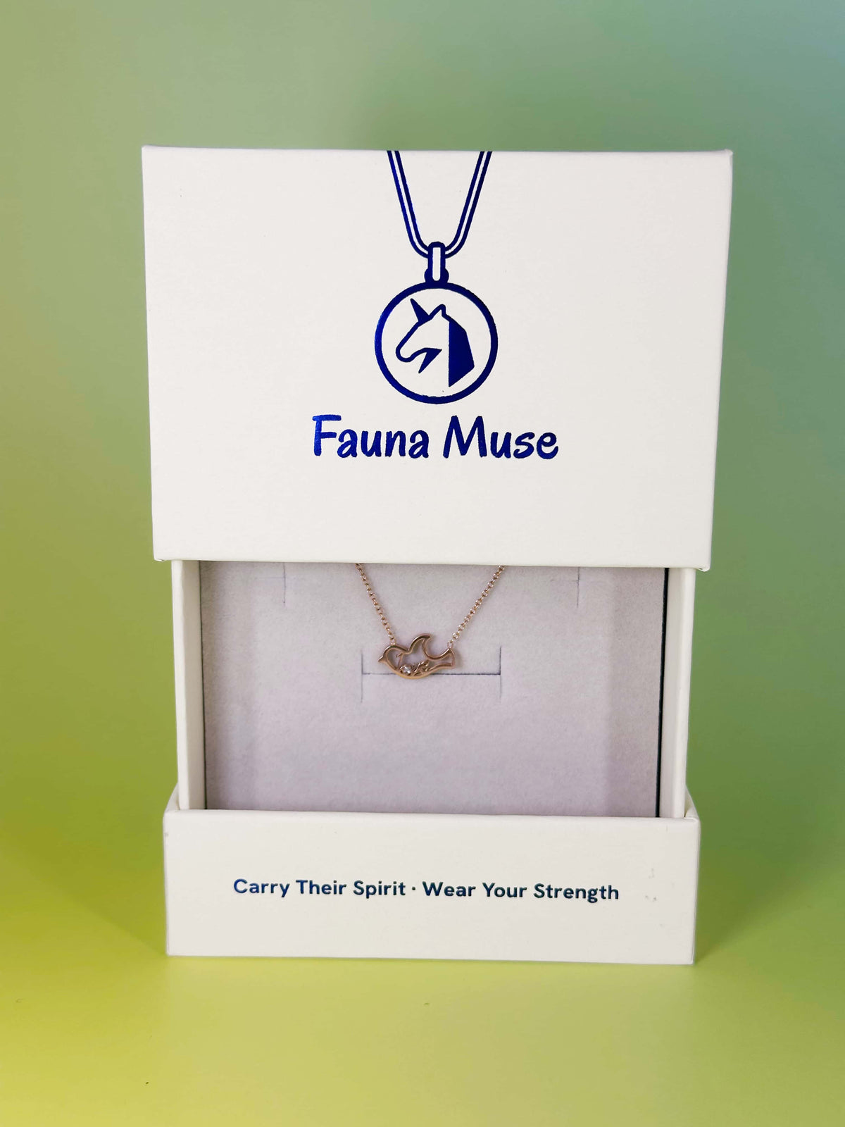 Fauna Muse rose gold bird pendant necklace displayed inside a white branded gift box