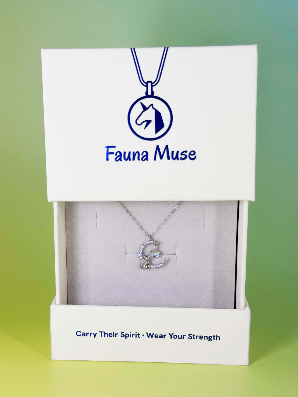 Fauna Muse silver cat on crystal crescent moon pendant necklace displayed inside a white branded gift box