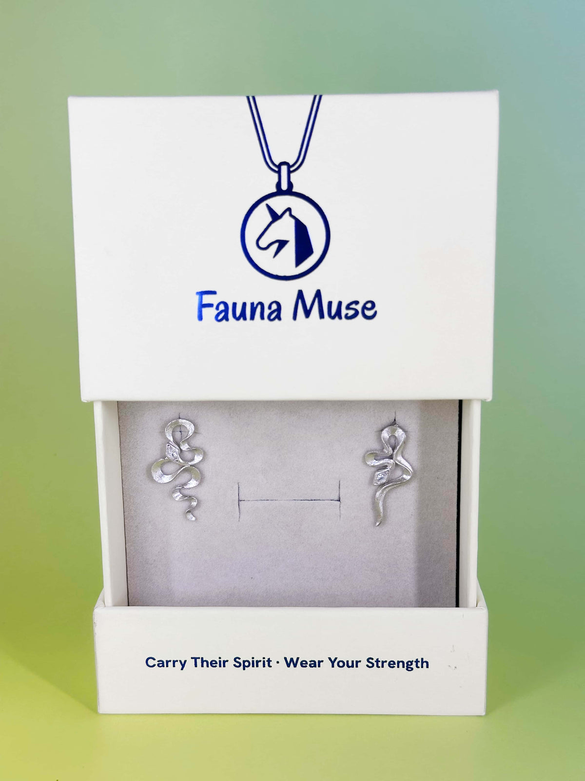 Fauna Muse textured silver snake stud earrings displayed in a white branded jewelry gift box