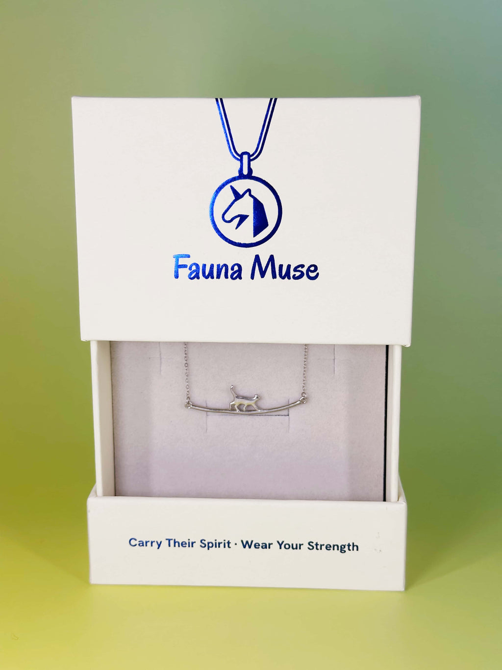 Fauna Muse silver walking cat curved bar necklace displayed inside a white branded gift box