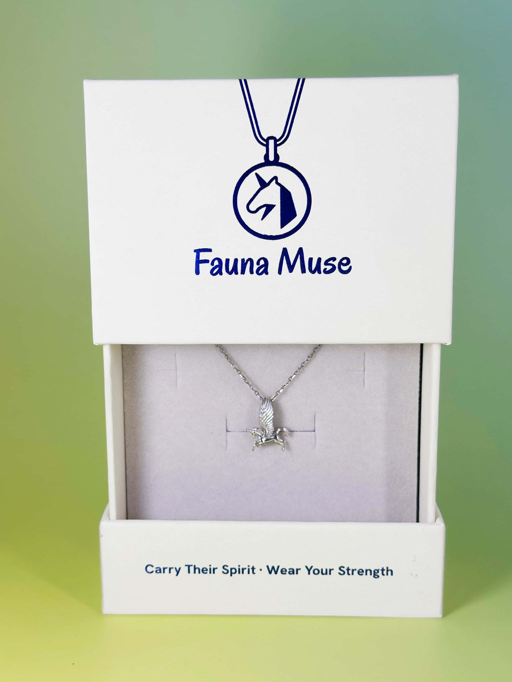Fauna Muse silver winged unicorn pendant necklace displayed inside a white branded gift box