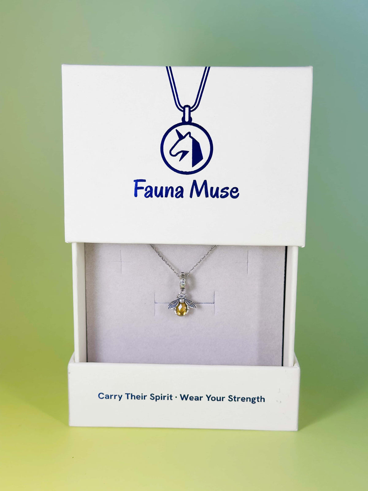 Fauna Muse silver bee pendant necklace with yellow crystal body displayed inside a white branded gift box