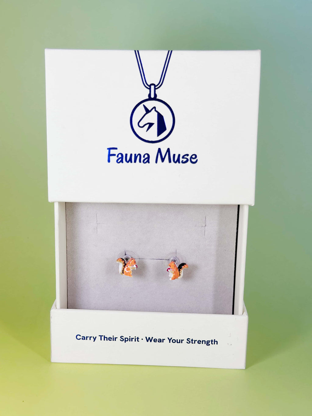 Fauna Muse cute squirrel stud earrings holding an acorn displayed in a white branded jewelry gift box